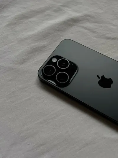 Black iPhone Pro on a white sheet