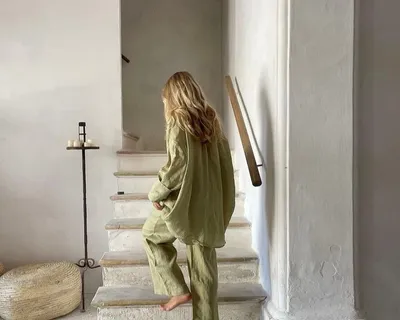 Woman walking down a whitewashed staircase
