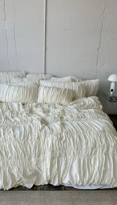 Soft white linen on an unmade bed
