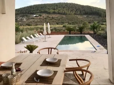 Pool terrace with a wooden dining table